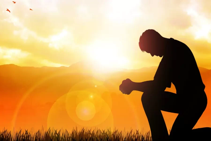 person kneeling to God in prayer