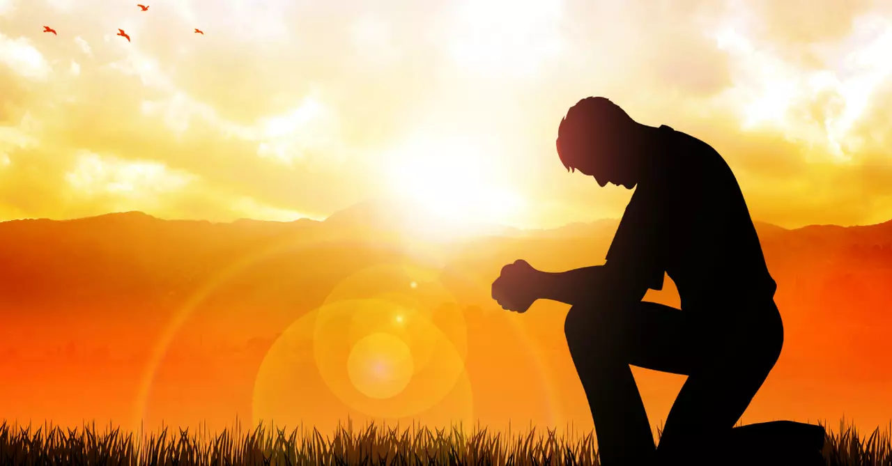 person kneeling to God in prayer