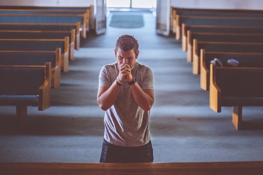man on knees praying