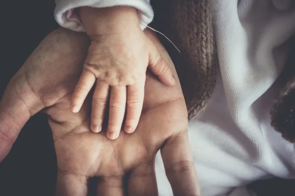 child holding on to fathers hand